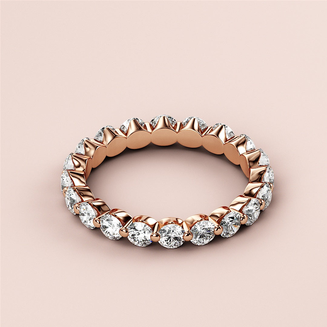Elegant 14K/18K rose gold eternity wedding band with marquise-cut diamonds, showcasing a luxurious and timeless design. 
