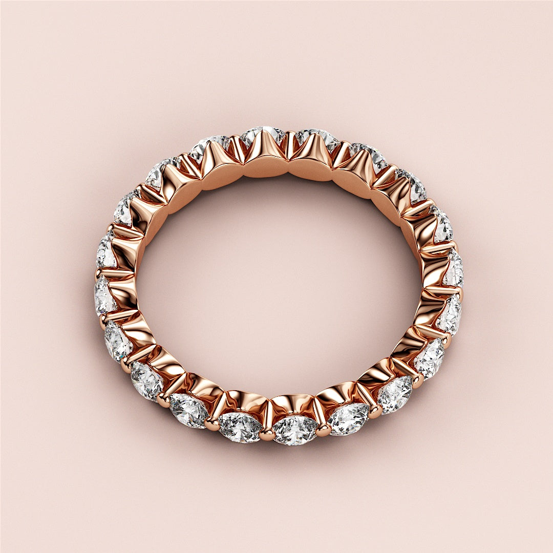 Elegant 14K rose gold eternity wedding band featuring round brilliant-cut diamonds in a timeless design. 