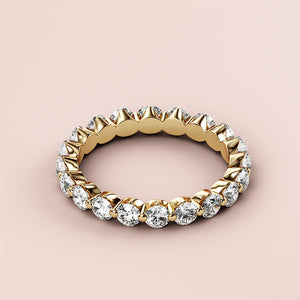 Elegant 14K/18K gold marquise diamond eternity wedding band with clear marquise diamonds, displayed on a soft beige background. 