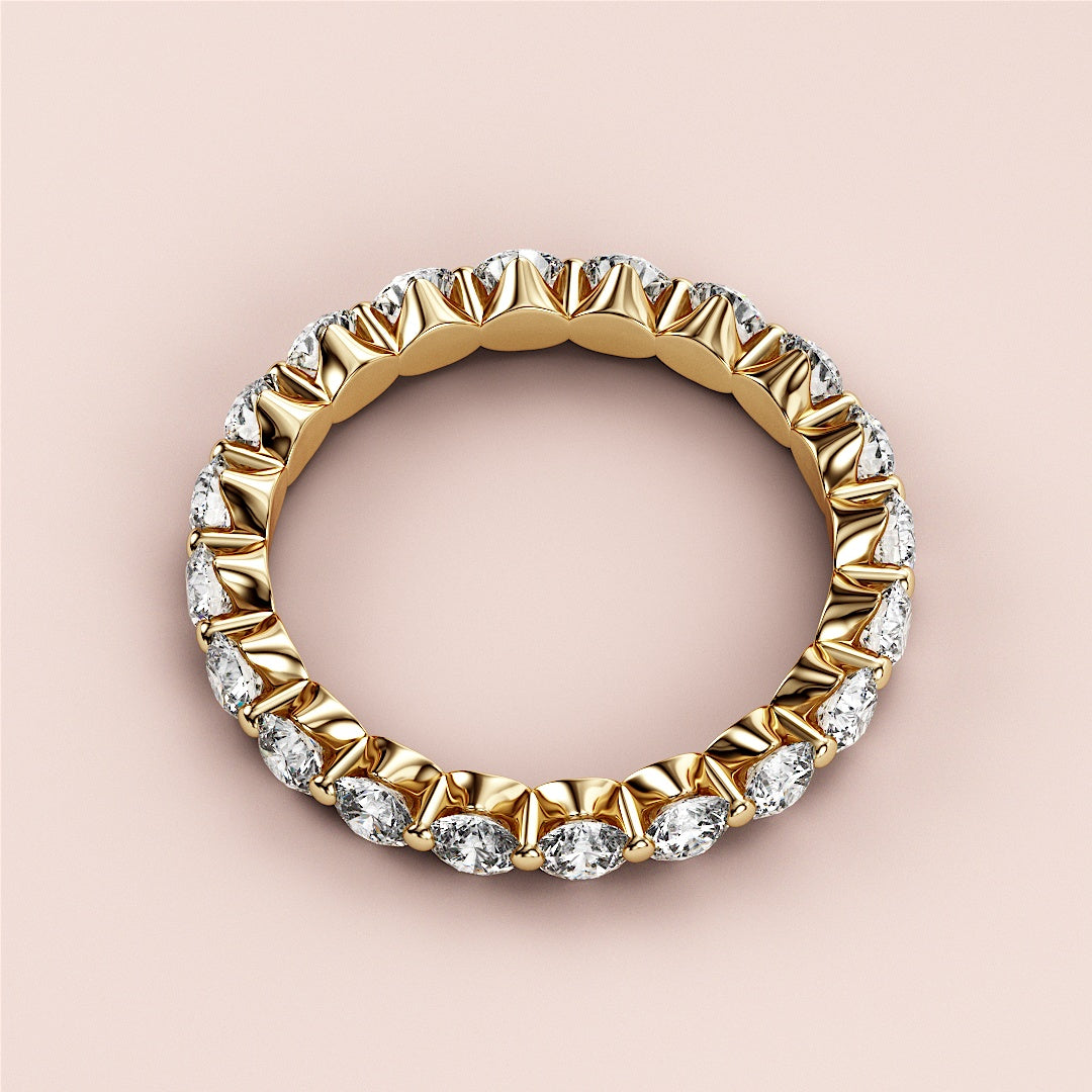 Elegant yellow gold eternity wedding band featuring round brilliant diamonds in 14K or 18K, exuding luxury and sophistication. 