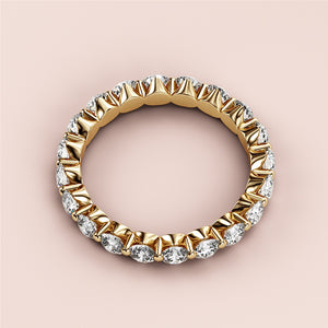Elegant yellow gold eternity wedding band featuring round brilliant diamonds in 14K or 18K, exuding luxury and sophistication. 