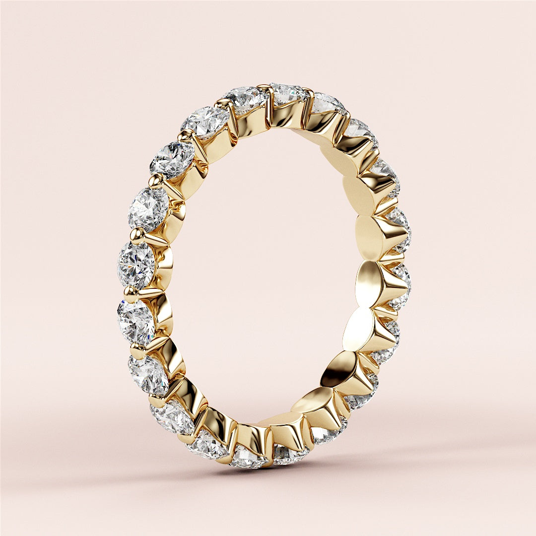 Elegant yellow gold eternity wedding band featuring round-cut diamonds in a seamless design, available in 14K or 18K. 