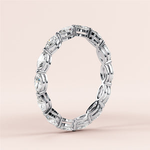 Elegant 14K/18K gold or platinum wedding band featuring marquise-cut diamonds in an eternity style, set against a neutral beige background. 