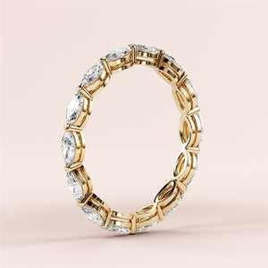 Elegant 14K yellow gold eternity band with marquise-cut diamonds, featuring an alternating infinity design, perfect for weddings. 