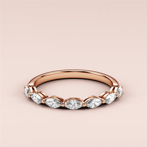 Elegant 14K rose gold eternity band featuring marquise-cut diamonds, perfect for weddings or special occasions. 