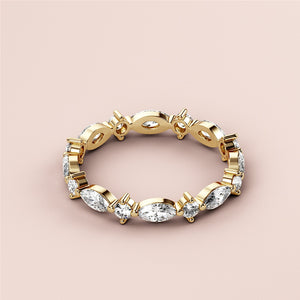Elegant 14K or 18K yellow gold marquise and round eternity wedding band with dazzling diamonds, displayed on a neutral background. 