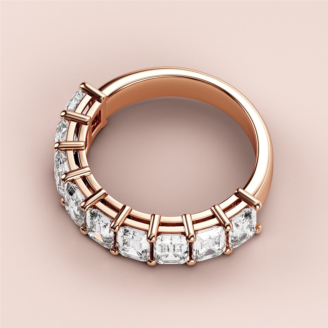 Luxurious rose gold wedding band featuring radiant emerald-cut diamonds, available in 14K, 18K, or platinum for elegant occasions. 