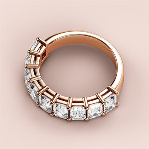 Luxurious rose gold wedding band featuring radiant emerald-cut diamonds, available in 14K, 18K, or platinum for elegant occasions. 