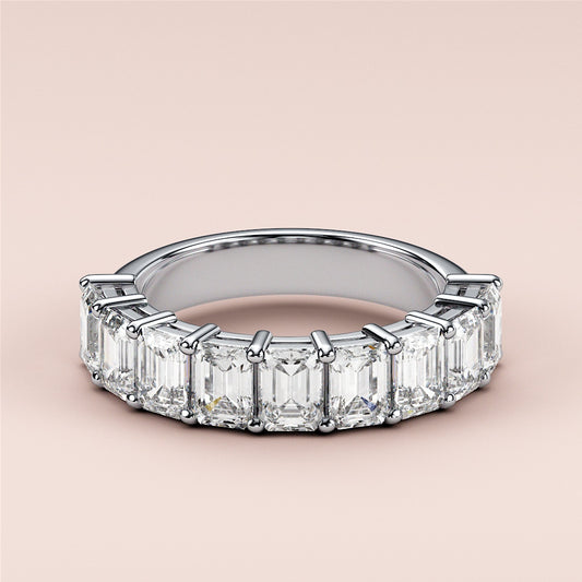 Elegant 14K or 18K white gold wedding band featuring emerald-cut diamonds in a modern eternity design. 