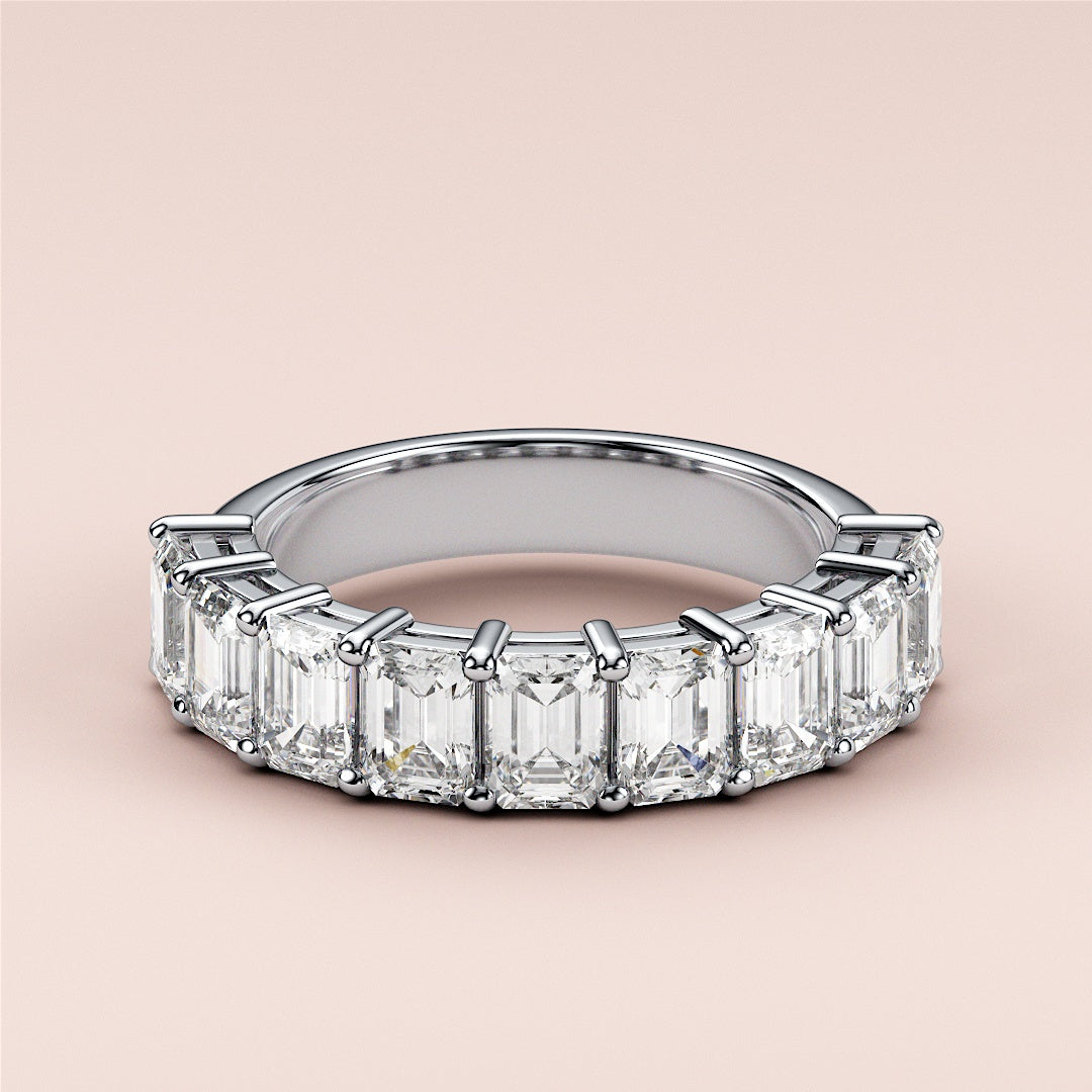 Elegant 14K or 18K white gold wedding band featuring emerald-cut diamonds in a modern eternity design. 