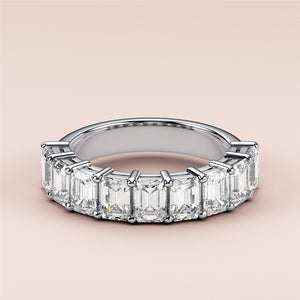 Elegant 14K or 18K white gold wedding band featuring emerald-cut diamonds in a modern eternity design. 
