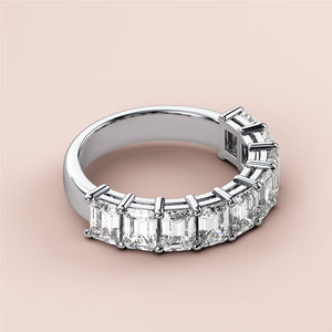 Elegant 14K white gold emerald half eternity wedding band featuring radiant-cut diamonds in a chic, symmetrical design. 