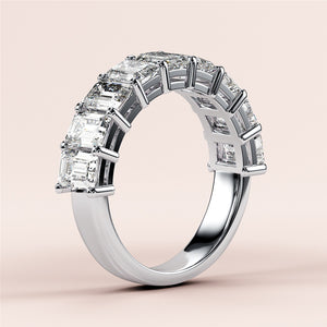 Elegant emerald-cut diamond wedding band in 14K or 18K white gold setting, featuring a row of sparkling emerald diamonds. 