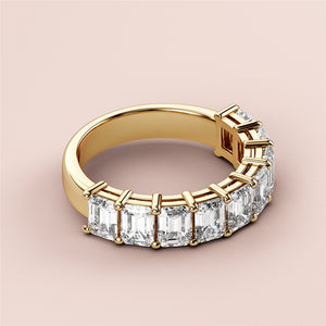 Elegant 14K yellow gold half eternity wedding band featuring radiant emeralds, showcasing timeless beauty and sophistication. 