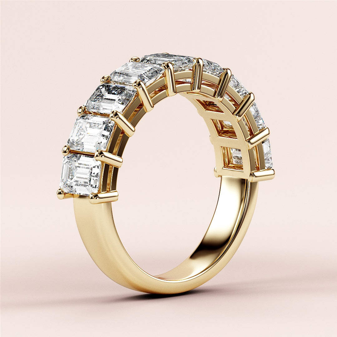 Elegant yellow gold half eternity wedding band featuring emerald-cut diamonds, available in 14K, 18K, or platinum settings. 
