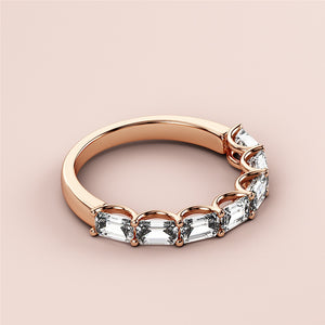 Rose gold half eternity wedding band featuring emeralds, available in 14K, 18K, and platinum for a timeless elegance. 