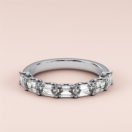 Elegant 14K or 18K white gold emerald half eternity wedding band, featuring a unique design and sparkling diamonds.  Perfect for any occasion. 