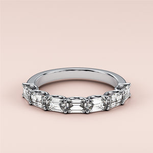 Elegant 14K or 18K white gold emerald half eternity wedding band, featuring a unique design and sparkling diamonds.  Perfect for any occasion. 