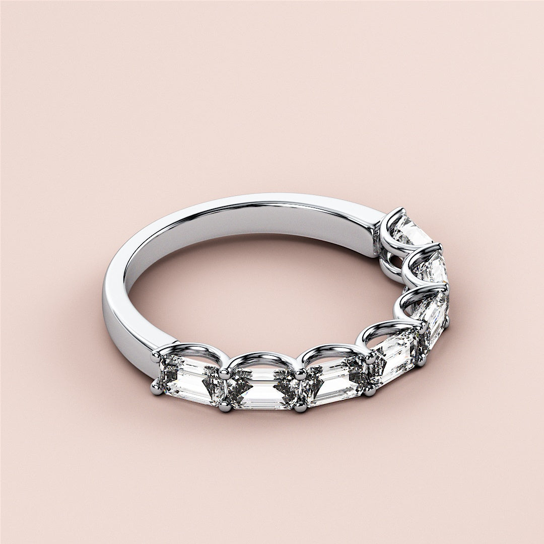 Elegant 14K white gold half eternity wedding band featuring emeralds in a delicate prong setting on a neutral background. |
 #14KRecycledWhiteGold
 #18KRecycledWhiteGold
 
 
 
 
 #Platinum
