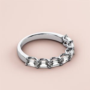Elegant 14K white gold half eternity wedding band featuring emeralds in a delicate prong setting on a neutral background. 