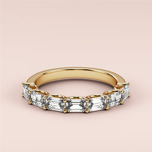 Elegant yellow gold wedding band featuring a unique half-circle design with emerald-cut diamond stones, crafted in 14K or 18K gold. 