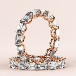 Elegant emerald-cut diamond eternity band in 14K rose gold, featuring sparkling diamonds.  Perfect for weddings and special occasions. 