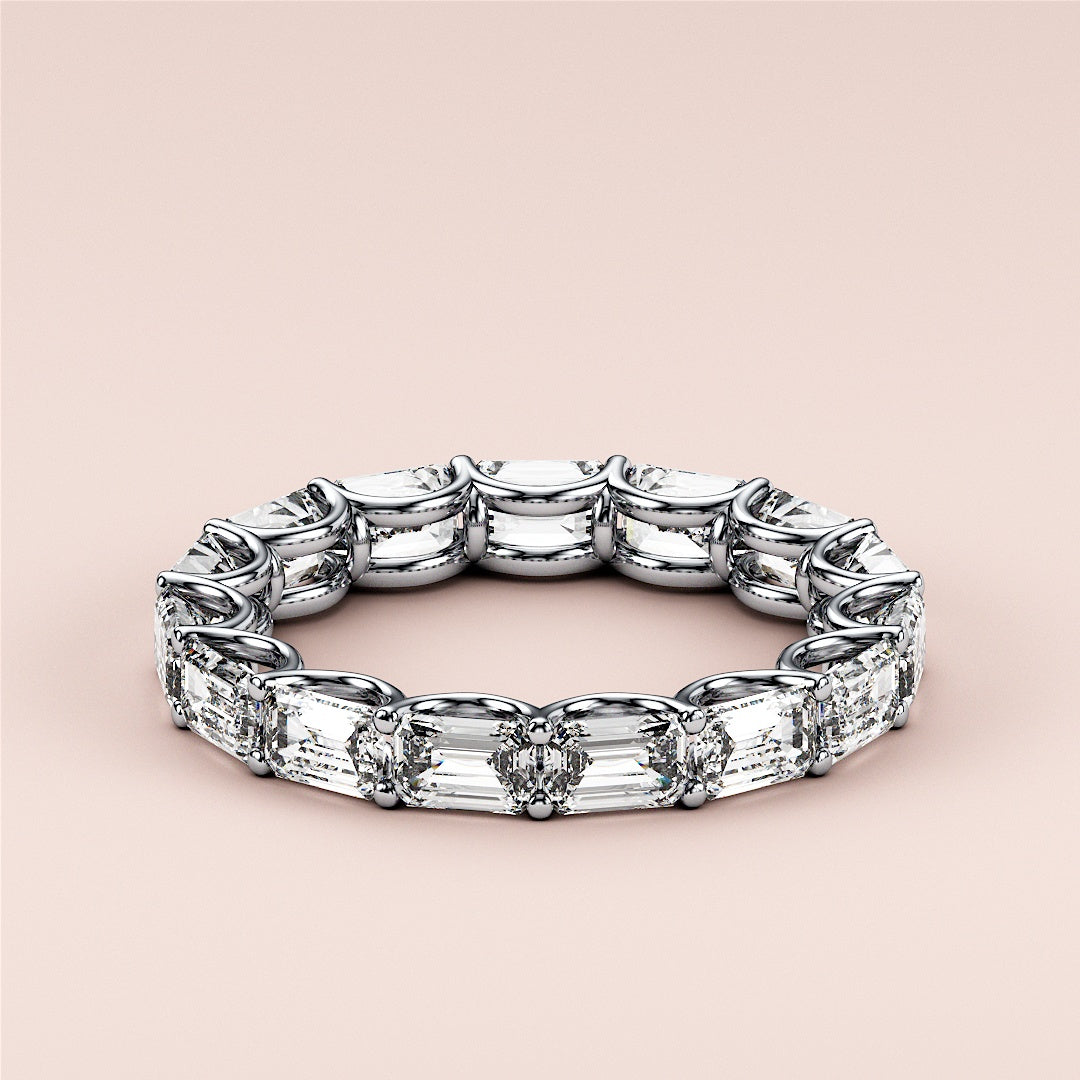 Elegant emerald-cut diamond eternity wedding band in 14K or 18K white gold or platinum, showcasing timeless luxury and intricate design. |
 #14KRecycledWhiteGold
 #18KRecycledWhiteGold
 
 
 
 
 #Platinum