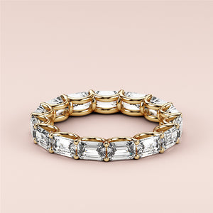 Elegant emerald-cut diamond eternity wedding band in 14K or 18K yellow gold, showcasing luxurious sparkle and intricate design. 