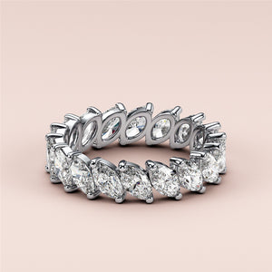14K and 18K white gold eternity band featuring marquise-cut diamonds, a luxurious wedding band set against a neutral background. 