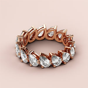 Elegant 14K Rose Gold eternity wedding band with dazzling pear-shaped diamonds, showcasing luxury and brilliance. 