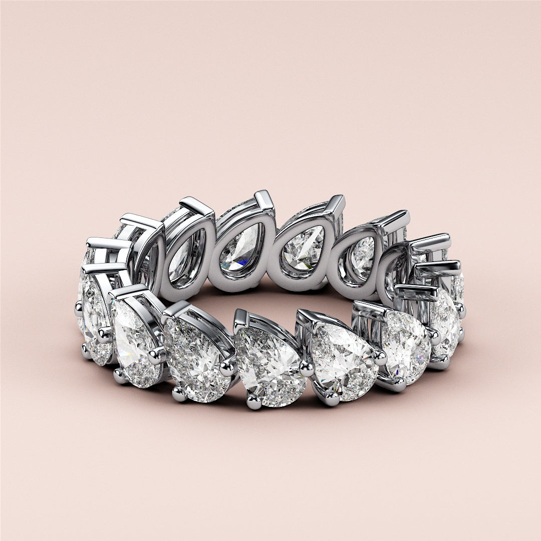 Elegant eternity wedding band featuring pear-shaped diamonds set in 14K or 18K gold or platinum, with a modern design. |
 #14KRecycledWhiteGold
 #18KRecycledWhiteGold
 
 
 
 
 #Platinum