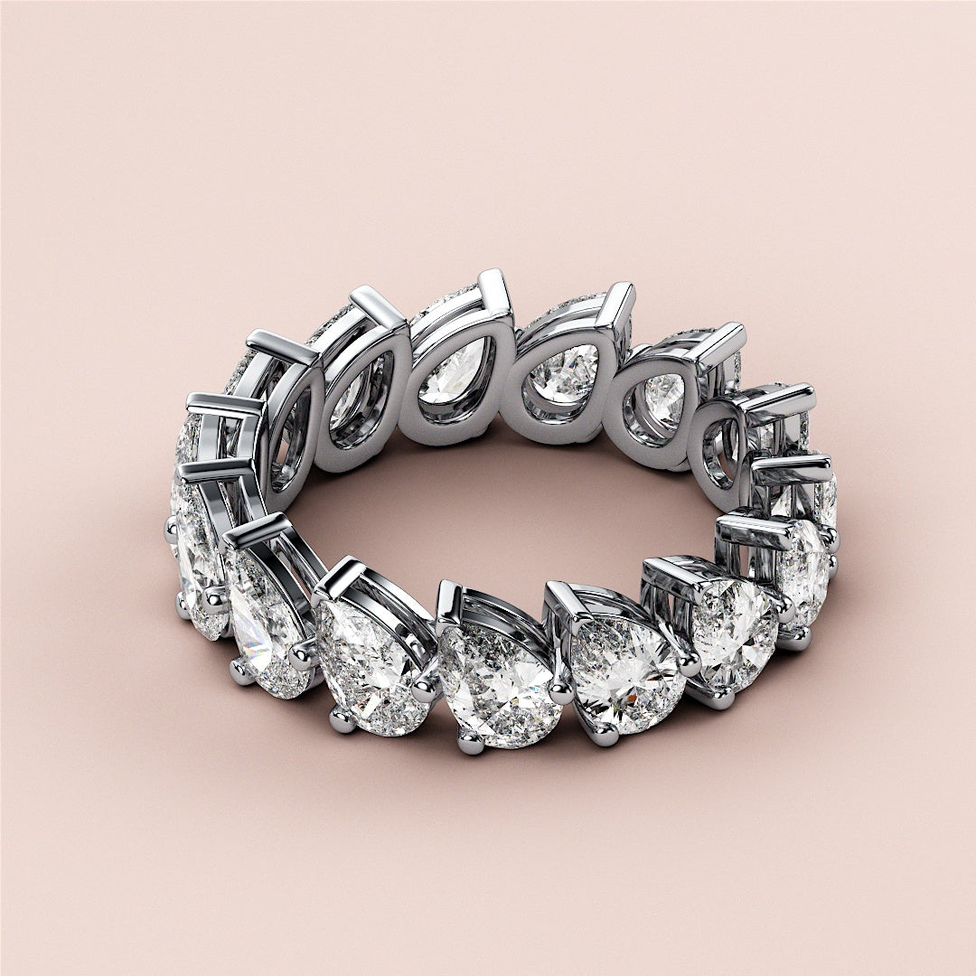 Elegant 14K and 18K white gold eternity wedding band featuring pear-shaped diamonds in a prong setting. |
 #14KRecycledWhiteGold
 #18KRecycledWhiteGold
 
 
 
 
 #Platinum