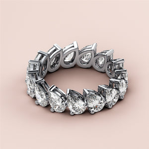 Elegant 14K and 18K white gold eternity wedding band featuring pear-shaped diamonds in a prong setting. 