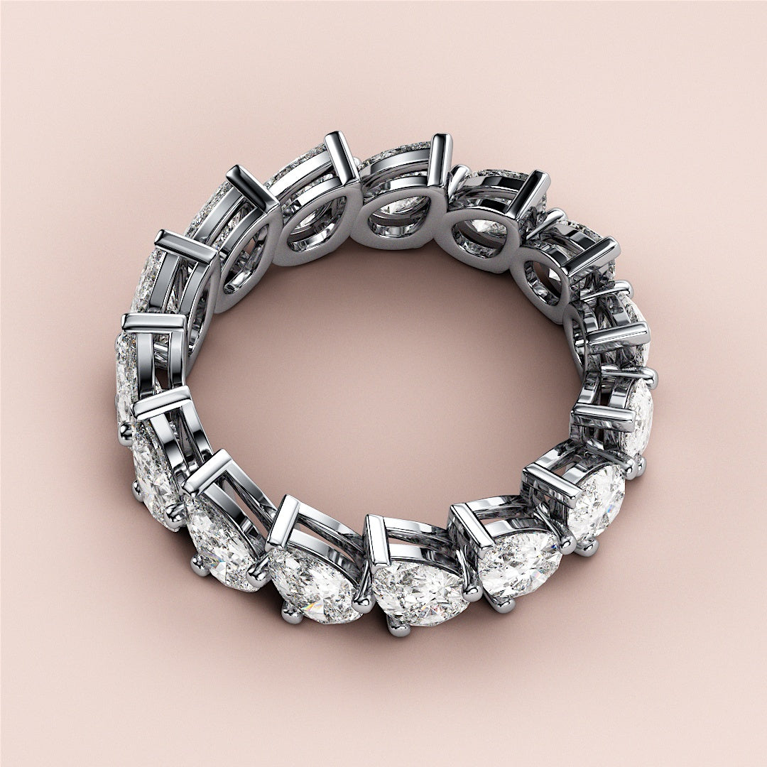 Stunning pear-shaped diamond eternity wedding band in 14K or 18K gold or platinum setting, elegantly displayed on soft background. |
 #14KRecycledWhiteGold
 #18KRecycledWhiteGold
 
 
 
 
 #Platinum