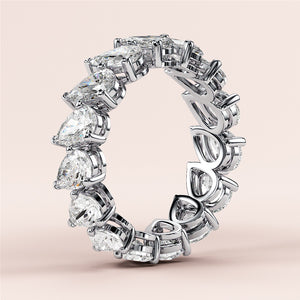 Elegant 14K or 18K gold wedding band featuring pear-shaped diamonds in a stunning eternity design, perfect for sophisticated styles. 