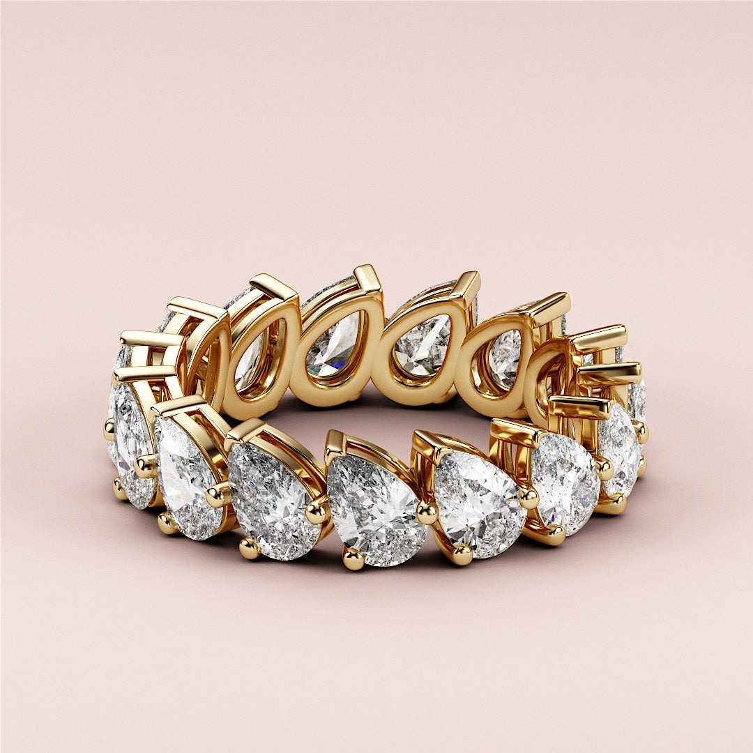 Elegant 14K/18K gold wedding band featuring pear-shaped diamonds; luxurious eternity ring jewelry, not worn on model. |
 
 
 #14KRecycledYellowGold
 #18KRecycledYellowGold