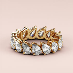 Elegant 14K/18K gold wedding band featuring pear-shaped diamonds; luxurious eternity ring jewelry, not worn on model. 