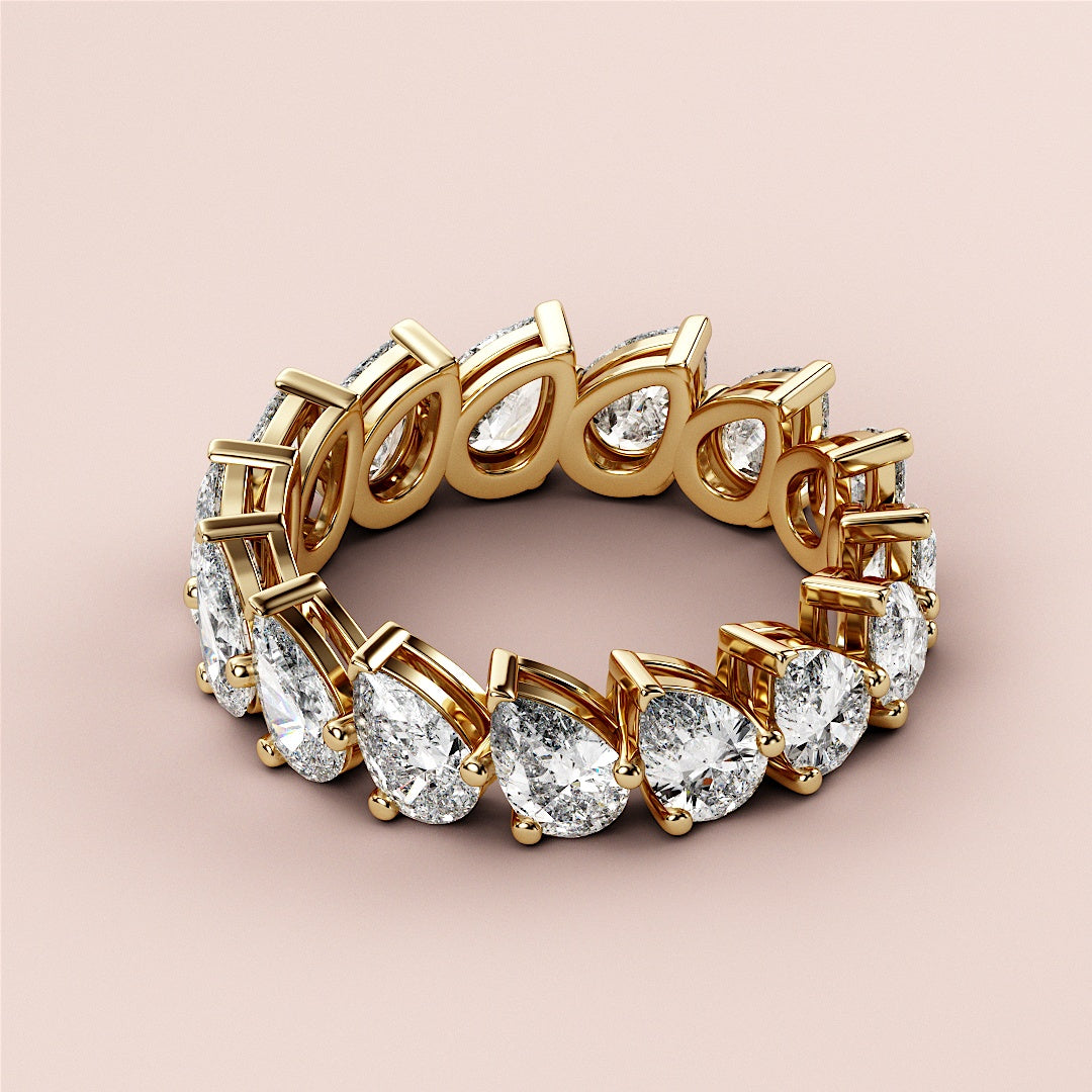 Luxurious 14K gold eternity wedding band featuring stunning oval cut diamonds in an elegant design on a neutral background. |
 
 
 #14KRecycledYellowGold
 #18KRecycledYellowGold