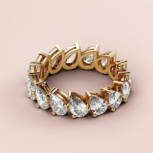 Luxurious 14K gold eternity wedding band featuring stunning oval cut diamonds in an elegant design on a neutral background. 