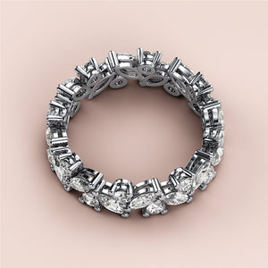 Elegant 14K/18K white gold eternity wedding band with marquise and pear-shaped diamonds, detailed view on creamy background. 