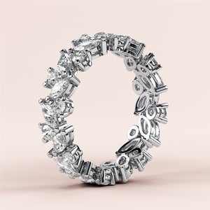 14K/18K/Platinum eternity band with marquise-cut and round diamonds, elegantly displayed on a neutral background. 