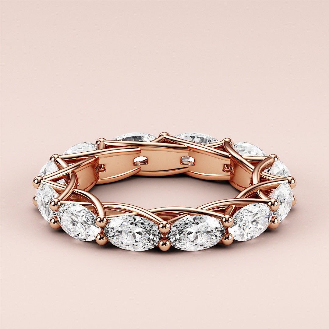 Elegant rose gold eternity band featuring marquise-cut diamonds, available in 14K and 18K gold or platinum.  Wedding band design. 