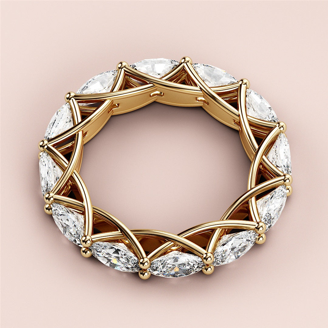 Elegant 14K yellow gold eternity band with marquise-cut diamonds in a crisscross prong setting, perfect for weddings. 