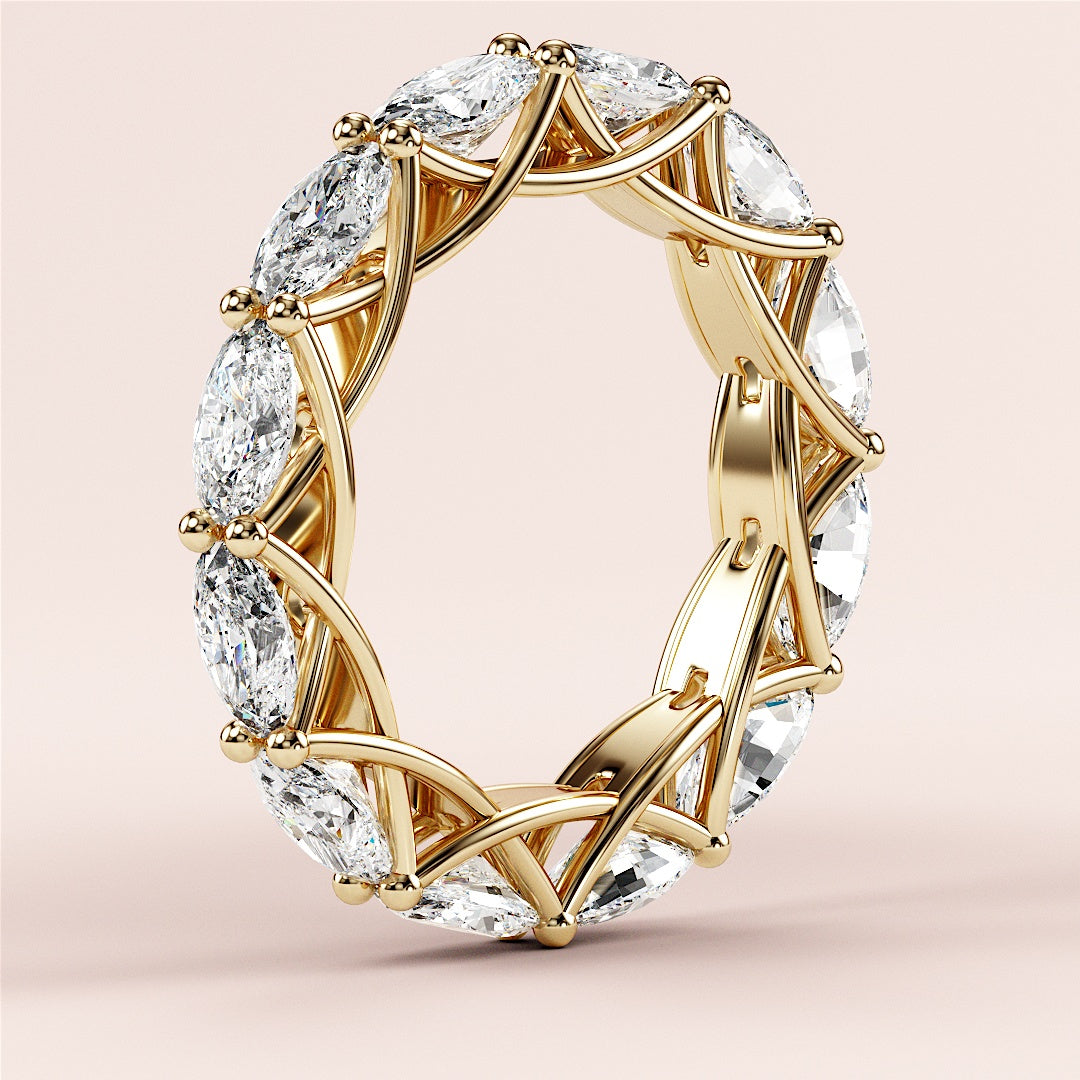 14K yellow gold eternity band ring featuring marquise-cut diamonds in an intricate lattice setting, not worn on model. 