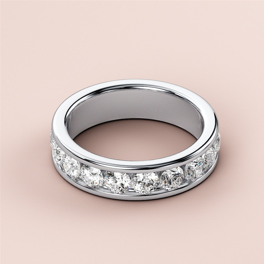 Women's wedding band featuring round-cut diamonds in channel setting, crafted in 14K or 18K gold or platinum.  Elegant eternity design. |
 #14KRecycledWhiteGold
 #18KRecycledWhiteGold
 
 
 
 
 #Platinum