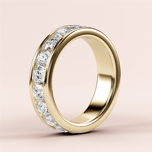 Elegant 14K gold channel-set diamond eternity band featuring brilliant-cut round diamonds, perfect as a wedding or anniversary ring. 