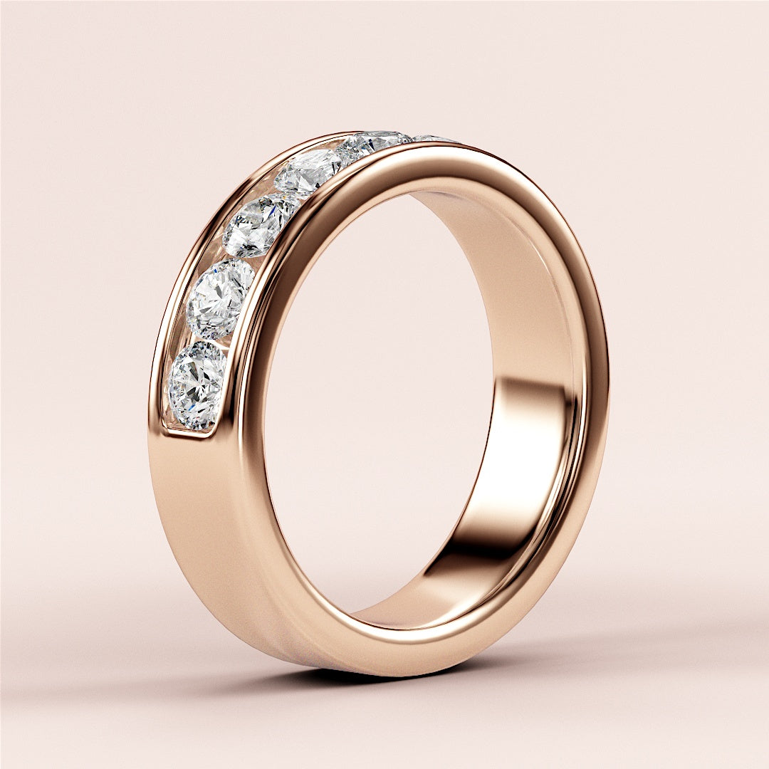 Elegant 14K or 18K rose gold diamond eternity band featuring round brilliant-cut diamonds in a classic channel setting. 