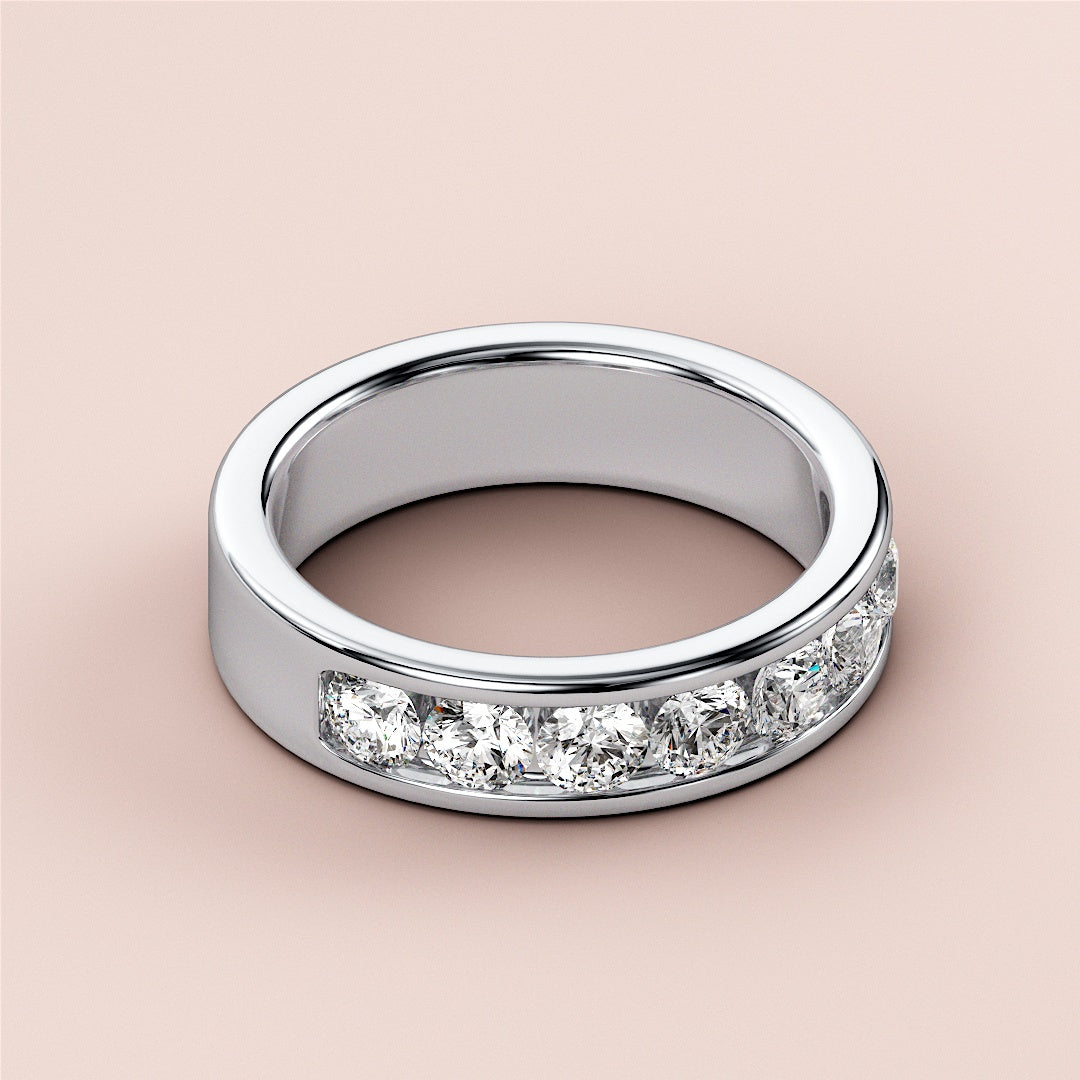 Elegant 14K or 18K platinum wedding band featuring round channel-set diamonds, perfect as an eternity ring. 