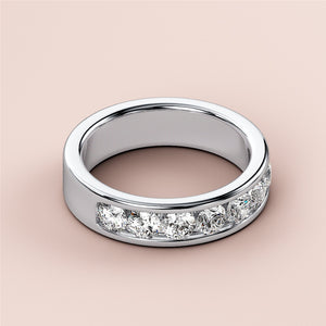 Elegant 14K or 18K platinum wedding band featuring round channel-set diamonds, perfect as an eternity ring. 