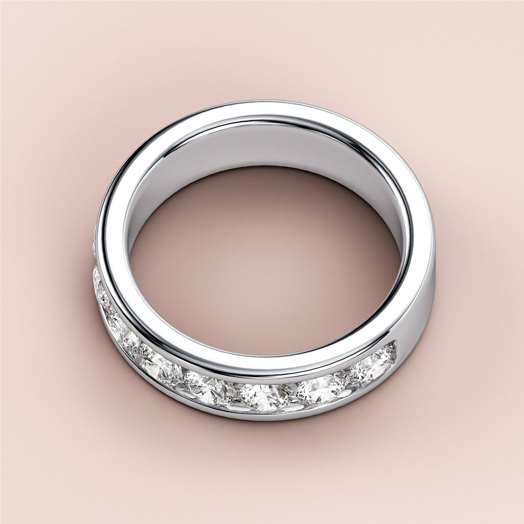Stunning white gold wedding band featuring round brilliant cut diamonds in a channel setting, available in 14K and 18K. 